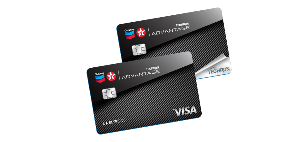 Two Chevron and Texaco Techron Advantage credit cards displayed at an angle, overlapping each other. Both cards feature a sleek black carbon fiber background with silver chip readers. The Chevron and Texaco logos are positioned on the upper left, and "Techron Advantage" is printed in bold white text. One card shows a silver peel-back corner with "with Techron" text underneath. The name "L. A. Reynolds" is printed on the lower left of the front card, and the Visa logo appears in silver on the bottom right.