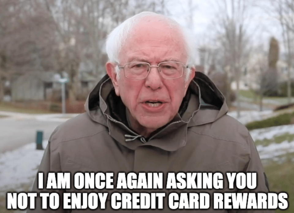 Meme featuring Bernie Sanders outdoors in a winter setting, wearing a brown coat and glasses, with trees and a snowy ground in the background. The text at the bottom reads, "I am once again asking you to not enjoy credit card rewards."