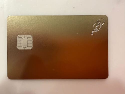 Gold-colored credit card with only the chip on the left side and the Robinhood feather logo in the upper right.