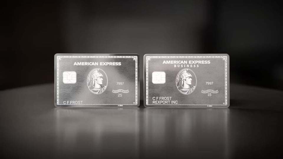 Two mirror-reflective American Airlines cards, one business, one personal, on a black background.