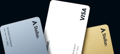 Parts of three credit cards. The left card is silver, the middle card is white, and the right card is gold. The StellarFi logo is visible on the silver and gold cards; the Visa logo is visible on the middle white card.