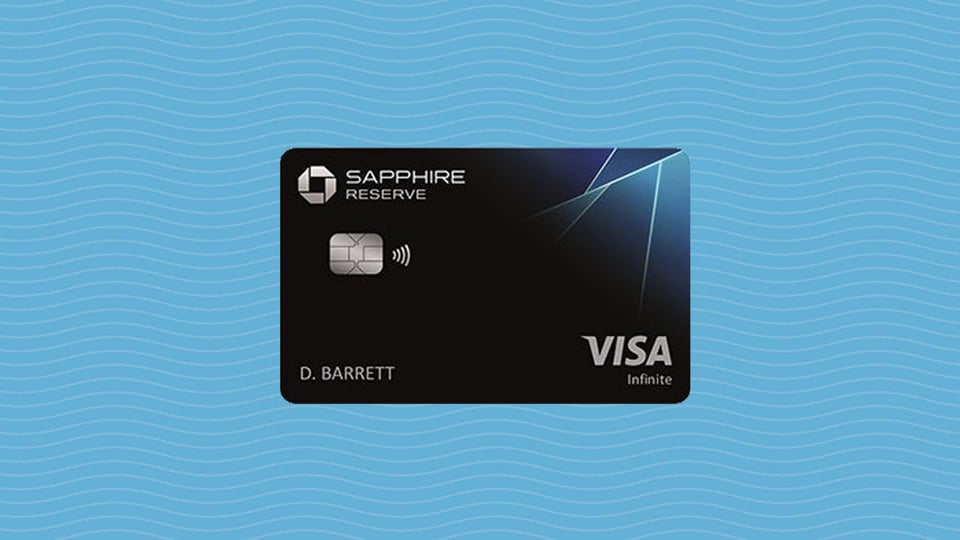 A Chase Sapphire Reserve Visa credit card against a light blue wavy background.