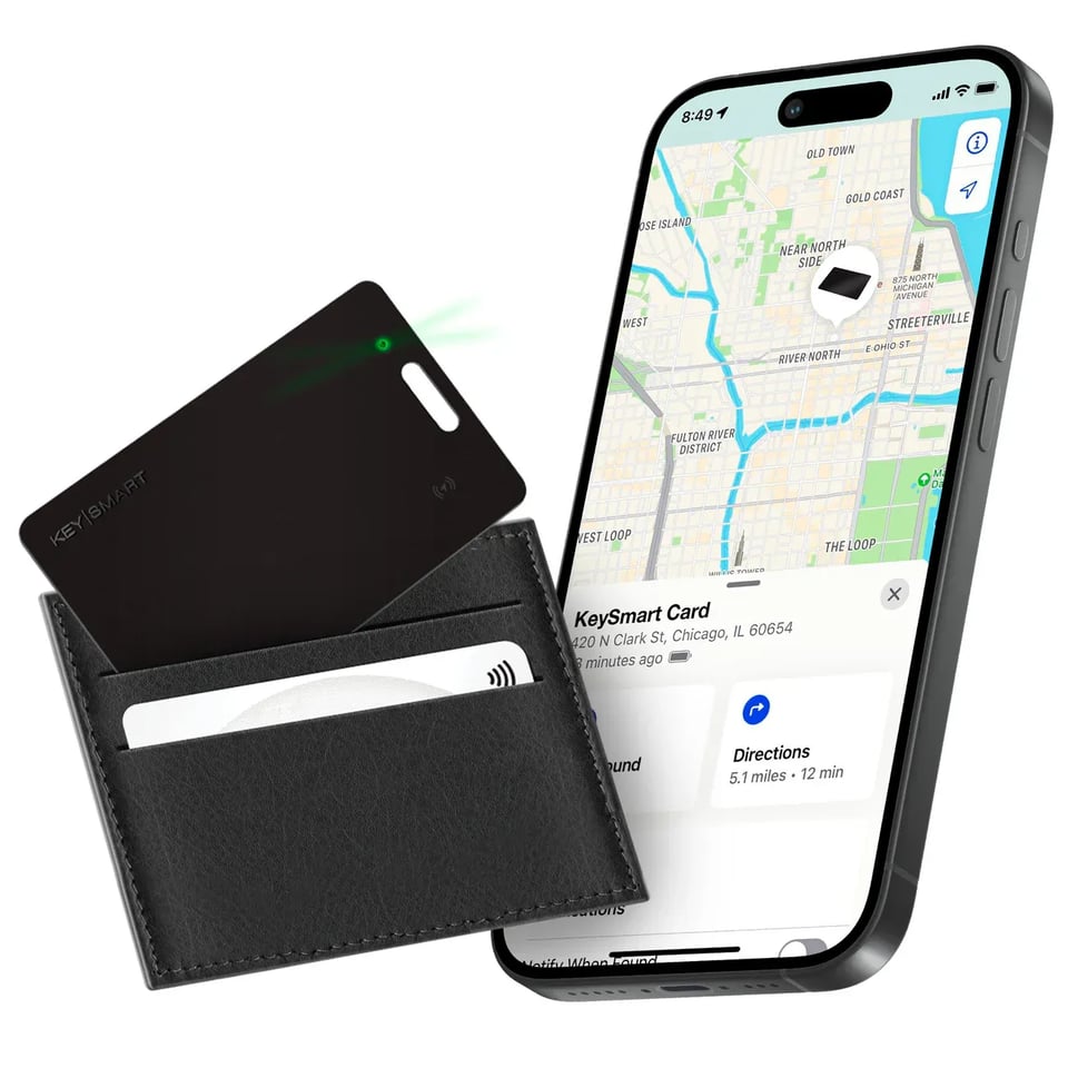 Image showcasing the KeySmart Card, a slim tracking device designed to fit into a wallet. The card is partially inserted into a sleek black leather cardholder, emitting a green light. Beside it, a smartphone screen displays a map with the location of the KeySmart Card, emphasizing its tracking functionality.