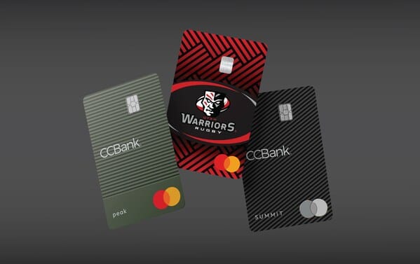 Three Mastercard credit cards on a gray background
