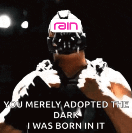 Meme of the movie character Bain with the Rain logo over his face. "You merely adopted the dark I was born in it" is in white over the bottom quarter of the image.